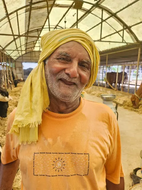 Farmer Ram Naresh Tiwari in his cow shed