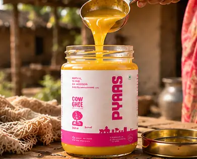 Golden ghee poured into a jar of PYAAS cow ghee