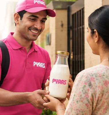 A PYAAS rider handing a glass bottle of milk to a customer at her door